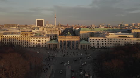 AERIAL:-Brandenburg-Gate-in-Berlin-with-view-on-Alexanderplatz-TV-Tower-in-beautiful-sunset-light