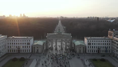 AERIAL:-Over-Brandenburg-Gate-with-view-on-Tiergarten-and-Berlin-Victory-Column-in-beautiful-Sunset-light