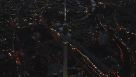 Berlin,-Germany-Capital-City-overview-at-Night-with-illuminated-TV-Tower-on-Alexanderplatz,-Aerial-high-angle-shot-slow