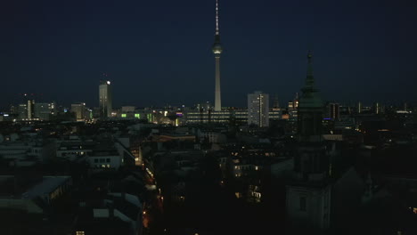 AERIAL:-View-of-empty-Berlin,-Germany-Cityscape-Skyline-at-Night-with-City-Light-During-COVID-19-Coronavirus-Pandemic