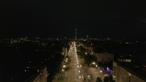 Aerial-View-of-Empty-Karl-Marx-Allee-Street-at-Night-towards-Alexanderplatz-TV-Tower-in-Berlin,-Germany-during-COVID-19-Coronavirus-Pandemic