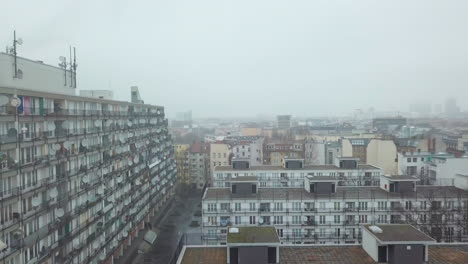 Big-Grey-Apartment-Complex,-Ghetto-Block-Building-in-Foggy-Cityscape-of-Berlin,-Kreuzberg-in-Germany,-poor-Neighbourhood-in-Germany,-Scenic-Aerial-View