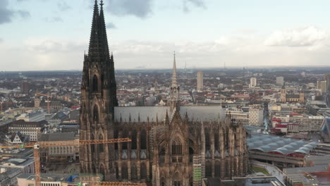 Backwards-reveal-of-Cathedral-Church-of-Saint-Peter.-Aerial-view-of-historic-gothic-Christian-landmark.-Cologne,-Germany