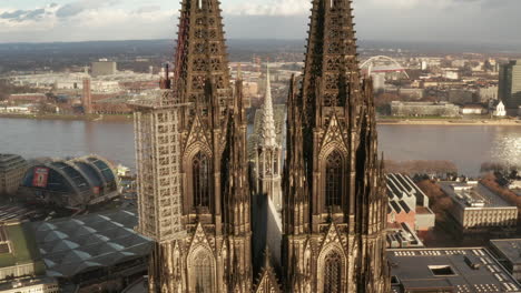 Aerial-ascending-footage-of-gothic-historic-religious-landmark.-Beautifully-ornamented-high-towers-of-Cathedral-Church-of-Saint-Peter.-Cologne,-Germany