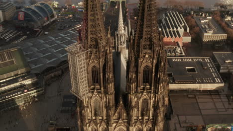 High-angle-view-of-gothic-Cologne-Cathedral-near-train-main-station.-Facade-lit-by-sun.-Cologne,-Germany