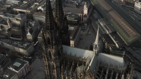 Cinematic-aerial-footage-of-gothic-historic-heritage.-High-angle-view-of-Cathedral-Church-of-Saint-Peter-and-tilt-up-reveal-building-in-city.-Cologne,-Germany