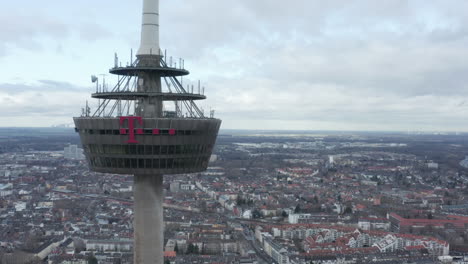 Orbit-shot-around-Colonius-telecommunications-tower.-Inaccessible-concrete-ring-with-advertisement.-Cologne,-Germany