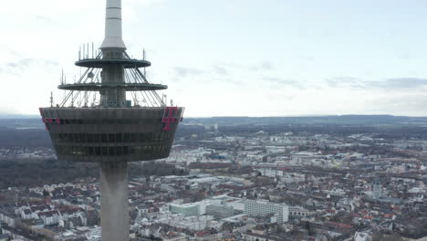 Orbit-shot-around-platform-on-Colonius-telecommunications-tower-with-various-antennas.-Buildings-in-city-in-background.-Cologne,-Germany