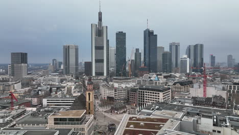 Backward-fly-above-building-in-town.-Panoramic-view-of-downtown-skyscrapers.-Frankfurt-am-Main,-Germany