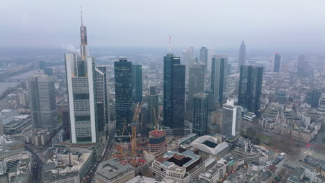 Building-new-skyscraper.-Construction-site-with-tower-cranes-near-group-of-high-rise-office-buildings.-Frankfurt-am-Main,-Germany