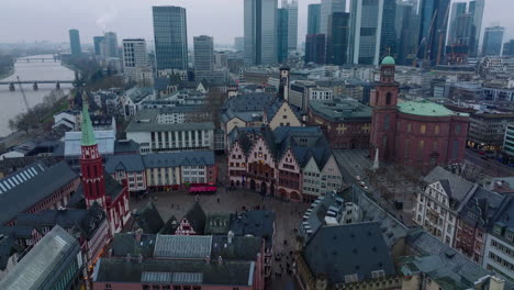 Historic-buildings-at-medieval-old-town-square.-Aerial-view-of-Roemerberg-and-modern-skyscrapers-in-background.-Frankfurt-am-Main,-Germany