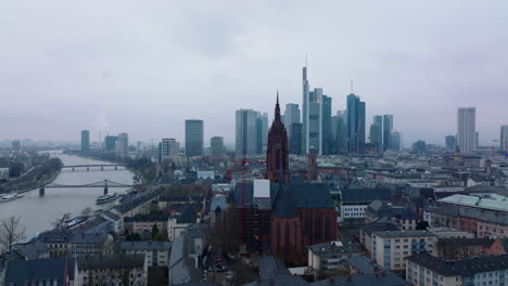 Slide-and-pan-footage-of-historic-Frankfurt-Cathedral.-River-flowing-through-city-and-group-of-modern-skyscrapers-in-background.-Frankfurt-am-Main,-Germany
