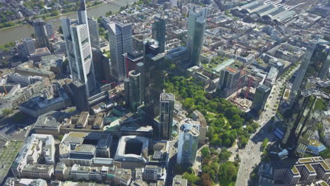 AERIAL-Above-Frankfurt-am-Main-with-Drone-looking-down-on-Skyscrapers-in-Beautiful-Summer-Sunshine