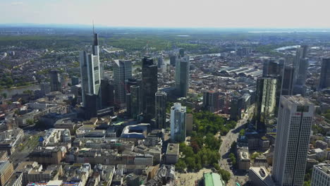 AERIAL-Above-Frankfurt-am-Main-with-Drone-looking-down-on-Skyscrapers-in-Beautiful-Summer-Sunshine