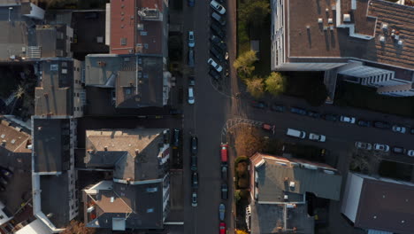 Aerial-birds-eye-overhead-top-down-view-of-calm-morning-in-streets-of-Bornheim-neighbourhood.-Cars-parked-on-side-of-road-in-front-of-buildings.-Vertical-panning.-Frankfurt-am-Main,-Germany