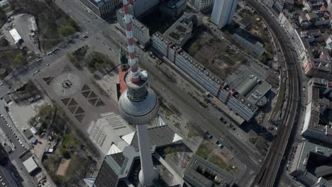 AERIAL:-Wide-View-of-Empty-Berlin,-Germany-Alexanderplatz-TV-Tower-with-almost-No-People-or-Cars-on-Beautiful-Sunny-Day-During-COVID-19-Coronavirus-Pandemic-March-2020