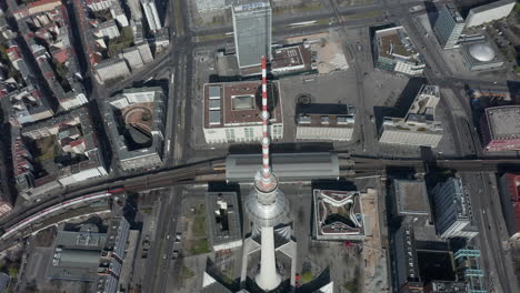 AERIAL:-Wide-View-of-Empty-Berlin,-Germany-Alexanderplatz-TV-Tower-with-almost-No-People-or-Cars-on-Beautiful-Sunny-Day-During-COVID-19-Coronavirus-Pandemic-March-2020
