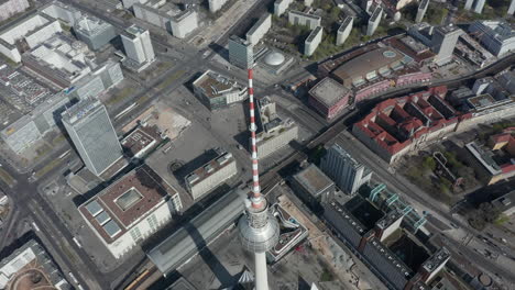 AERIAL:-Slow-Flight-over-Small-Bridge-over-Spree-in-Berlin,-Germany-with-view-on-Alexanderplatz-TV-Tower