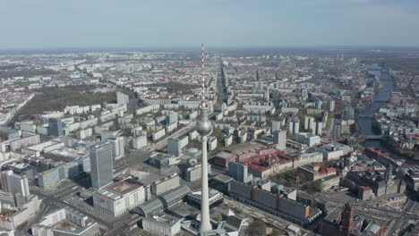 AERIAL:-Super-Close-Up-View-of-the-Alexanderplatz-TV-Tower-in-Berlin,-Germany-on-hot-summer-day