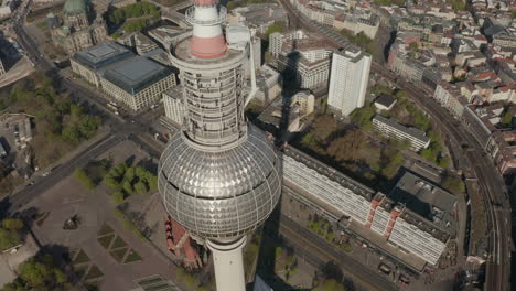 AERIAL:-Wide-View-of-the-top-of-Alexander-Platz-TV-Tower-with-Empty-Berlin,-Germany-Streets-in-background-on-hot-summer-day-during-COVID-19-Corona-Virus-Pandemic