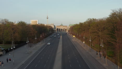 AERIAL:-Flight-towards-Empty-Brandenburger-Tor-in-Berlin,-Germany-due-to-Coronavirus-COVID-19-Pandemic-in-Sunset-Light