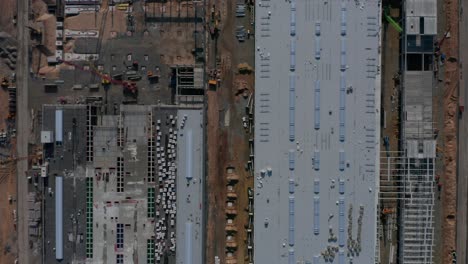 Generic-Top-View-of-a-big-construction-site-with-building-structure-and-heavy-machinery-equipment-of-builders,-Aerial-Birds-Eye-View