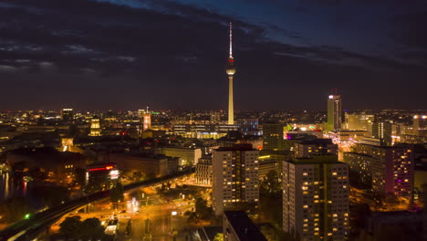 Berlin-at-Night-Aerial-Hyperlapse,-Motion-Time-Lapse-of-Alexanderplatz-TV-Tower-Establishing-Shot-and-beautiful-city-lights,-Hyper-Lapse
