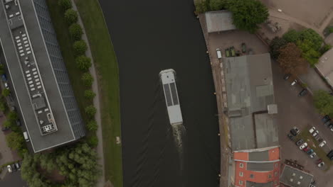 AERIAL:-Birds-Eye-Overhead-View-Following-a-Boat-on-River