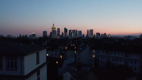 Rising-drone-footage-revealing-cityscape-in-blue-hour.-Downtown-panorama-with-skyscrapers-against-pink-blue-sunset-sky.-Frankfurt-am-Main,-Germany