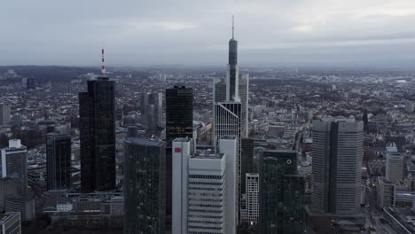 Fly-above-large-city-on-cloudy-day.-Aerial-panoramic-footage-of-office-towers-in-business-borough.-Frankfurt-am-Main,-Germany