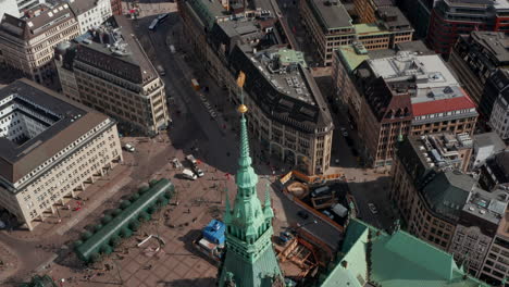 Aerial-view-of-Hamburg-city-hall-green-roof-with-pedestrians-and-urban-traffic-on-the-streets-below