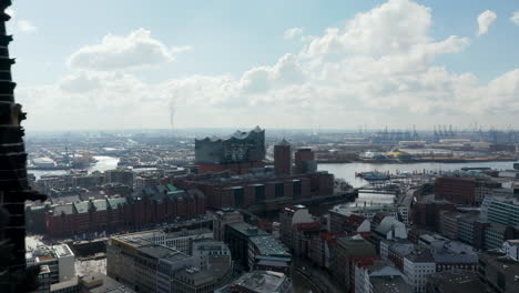 Aerial-dolly-view-of-St.-Nikolai-world-war-Memorial-and-Elbphilharmonie-in-Hamburg-city-center