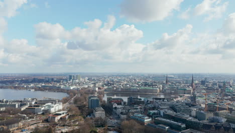 Panoramic-aerial-view-of-Hamburg-city-center-with-church-spires-rising-above-the-cityscape