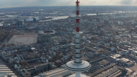 Close-up-aerial-view-of-red-and-white-antennas-on-top-of-Heinrich-Hertz-TV-tower-in-Hamburg,-Germany