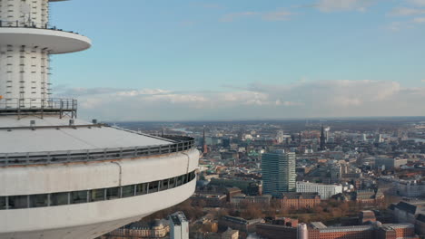 Reveal-of-Hamburg-city-skyline-behind-Heinrich-Hertz-TV-tower-rising-above-Hamburg-urban-cityscape