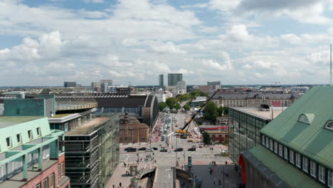 Forwards-fly-above-busy-street-leading-along-Hamburg-Hauptbahnhof-building.-Part-of-street-is-closed-due-to-truck-crane-work.-Free-and-Hanseatic-City-of-Hamburg,-Germany