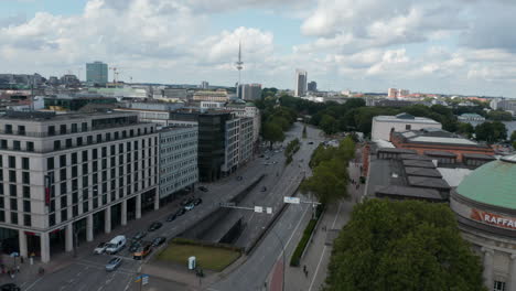 Flight-above-wide-multilane-Main-Street-leading-along-Art-Museum-Hamburger-Kunsthalle-with-Tall-Heinrich-Hertz-Turm-TV-Tower-in-Background.-Free-and-Hanseatic-City-of-Hamburg,-Germany