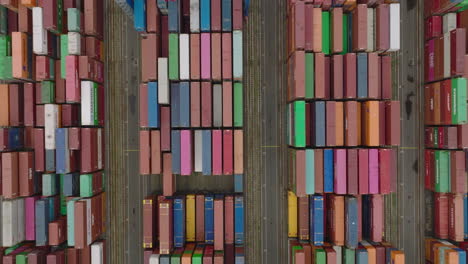 High-angle-view-of-rows-of-cargo-containers-with-goods-stacked-in-harbour.-Arranged-colourful-boxes.-Intermodal-transport-and-global-logistics.-Hamburg,-Germany