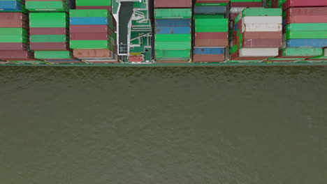 Fly-over-majestic-container-cargo-boat-in-harbour.-Top-down-shot.-Intermodal-transport-and-global-logistics.-Hamburg,-Germany