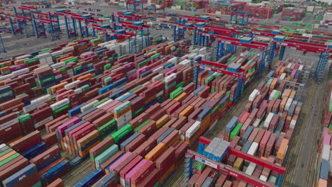 Forwards-fly-above-rows-of-stacked-naval-containers-in-harbour-logistic-terminal.-Intermodal-transport-and-global-logistics.-Hamburg,-Germany