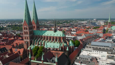 Aerial-shot-of-historic-city-centre.-Orbiting-around-brick-gothic-St.-Marys-Church.-Luebeck,-Schleswig-Holstein,-Germany