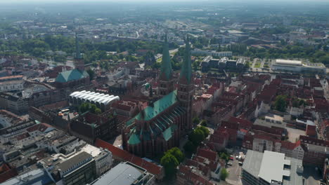 Aerial-panoramic-footage-of-historic-part-of-town.-Showing-St.-Marys-Church,-St.-Peters-Church-and-in-distance-Luebeck-Cathedral.-Luebeck,-Schleswig-Holstein,-Germany