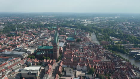 Aerial-panoramic-view-of-old-town-with-red-brick-houses,-churches-and-buildings.-Luebeck,-Schleswig-Holstein,-Germany