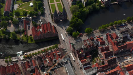 High-angle-view-of-old-town-with-red-brick-buildings.-Orbiting-around-Holsten-Gate.-Luebeck,-Schleswig-Holstein,-Germany