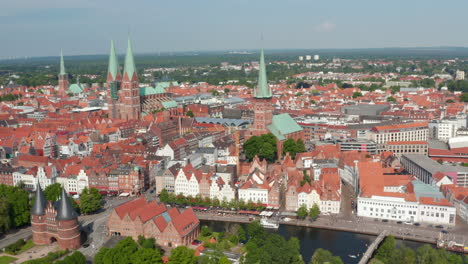 Aerial-panoramic-view-of-medieval-city-centre.-Brick-gothic-landmarks-Holsten-Gate,-St.-Marys-and-St.-Peters-churches.-Luebeck,-Schleswig-Holstein,-Germany