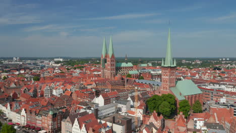 Backwards-reveal-of-medieval-old-town-centre.-Brick-buildings-and-tall-church-towers.-Luebeck,-Schleswig-Holstein,-Germany
