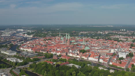 Aerial-panoramic-view-of-medieval-city-centre.-Brick-buildings-in-historic-part-of-town-in-UNESCO-world-heritage-site.-Luebeck,-Schleswig-Holstein,-Germany