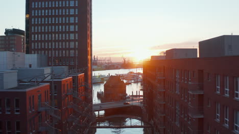 Sunset-in-Hamburg-harbor-with-modern-apartment-buildings-on-the-banks-of-river-Elbe