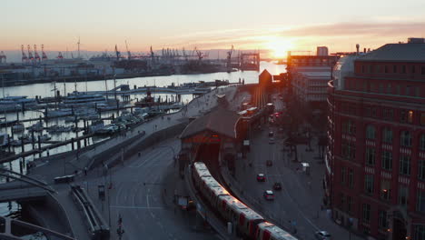 Train-leaving-the-station-near-Hamburg-harbor-by-the-river-Elbe-during-sunset