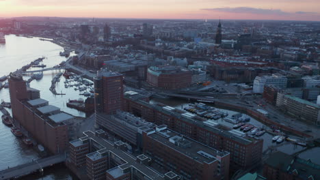 Aerial-view-of-urban-modern-city-center-of-Hamburg-with-residential-buildings-and-famous-landmarks-along-Elbe-river